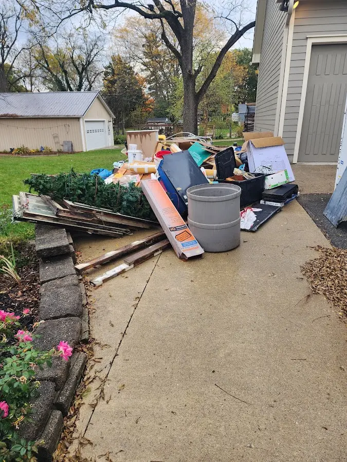 Dumpster being loaded with debris for Commercial Dumpster Rental in Wrentham